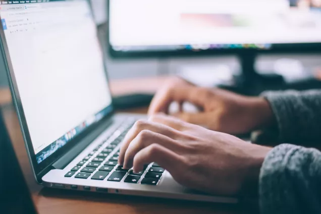 close up photo of hands typing on a lap top. Photo by Glenn Carstens-Peters on Unsplash